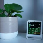 Een moderne luchtreiniger in een lichte woonkamer met planten en frisse lucht, ideaal voor het verlichten van hooikoorts.